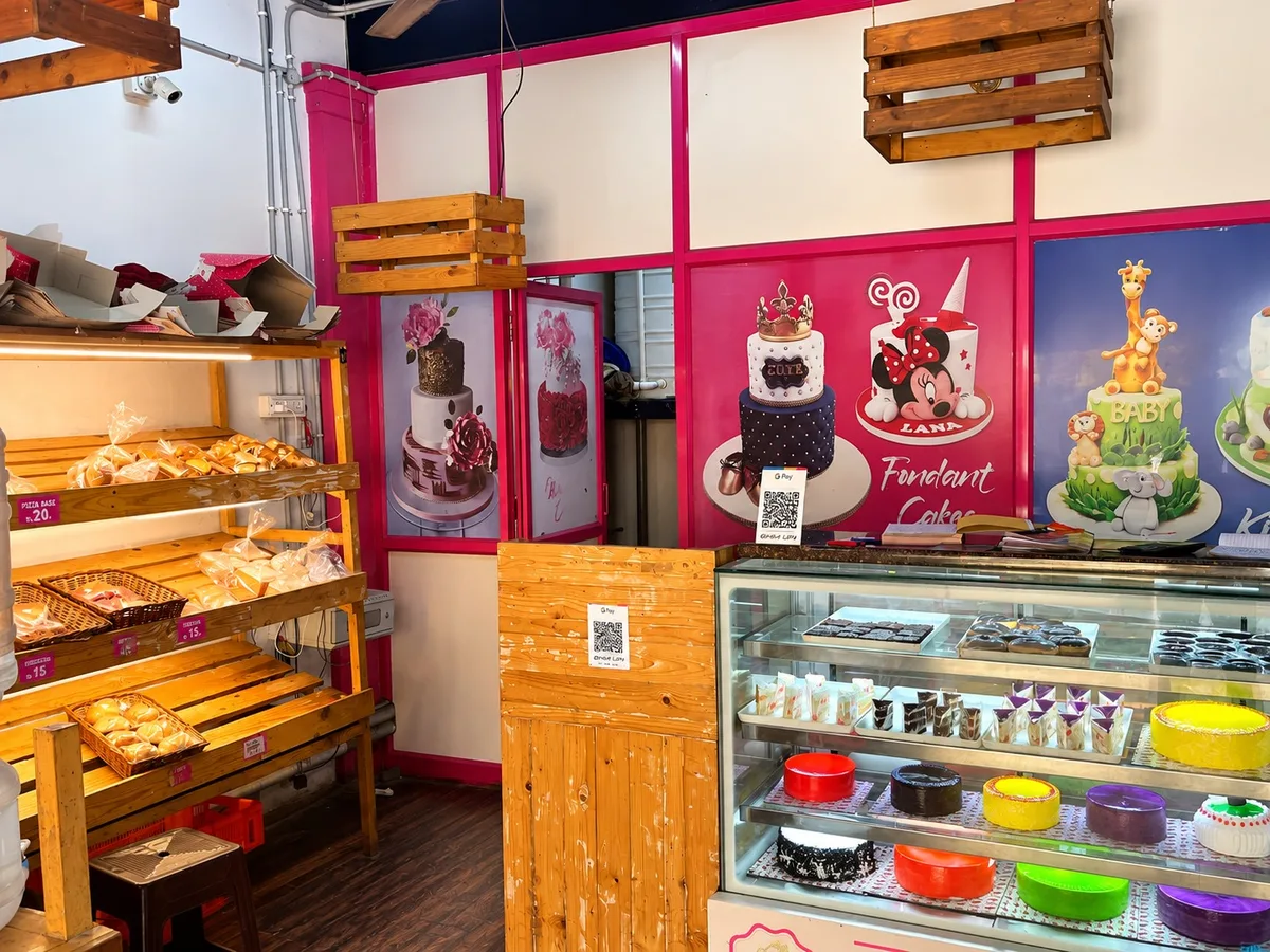 Display counter with cakes, pastries and fondant cake posters at Lollipop